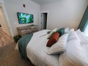 a bedroom with a bed with pillows and a tv on the wall at Monroe Mountain Suite - Castle Rock Condos in Richfield