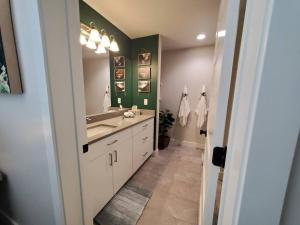 a bathroom with a sink and a large mirror at Monroe Mountain Suite - Castle Rock Condos in Richfield