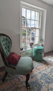 a living room with a chair and a window at The Red Lion Arlingham in Gloucester