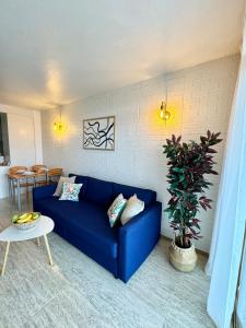a blue couch in a living room with a table at Apartamento completo junto a la playa in Salou +40 photos