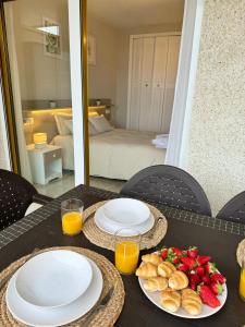 a table with plates of food and a plate of fruit at Apartamento completo junto a la playa in Salou