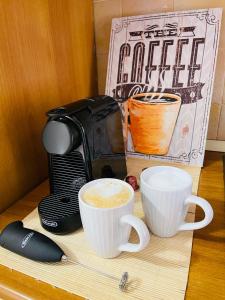 una macchinetta del caffè e due tazze su un tavolo di La Casa di Gió in Centro a Olbia