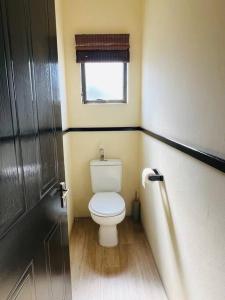 a small bathroom with a toilet and a window at La Mercy heaven in La Mercy