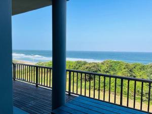 a balcony with a view of the beach at La Mercy heaven in La Mercy