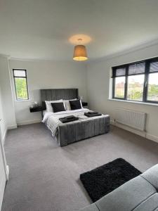 a bedroom with a bed and a couch in it at Modern 2 Bedroom House, Edinburgh. in Millerhill