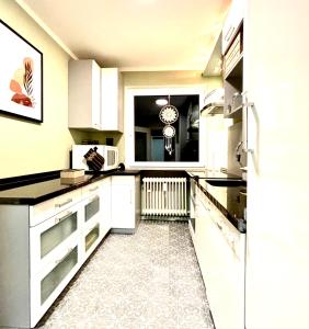 a kitchen with white appliances and a large window at Business- Apartment Worms # guesthouse- Monteure willkommen in Worms