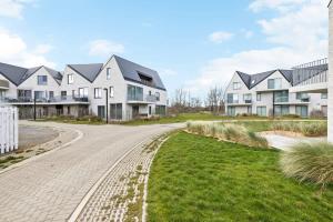 a driveway in front of a house at Huswell - Apartment with natural swimming pool in Middelkerke