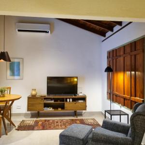 a living room with a tv and a couch at Pouso 22 in Pirenópolis