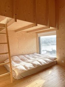 a bedroom with a bunk bed and a ladder at Beautiful wood house and view in Audierne