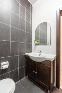a bathroom with a sink and a toilet and a mirror at A Bright & Lovely 2 Bedroom Apartment 1 minute walk from promenade apartment 3 in Il-Gżira