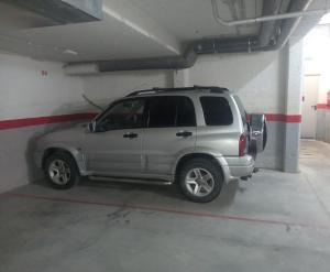a silver suv parked in a parking garage at Apartamento La Larri in Bielsa