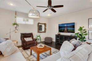 a living room with two couches and a ceiling fan at Harribo Townhome - Walk Everywhere - Downtown Fay in Fayetteville