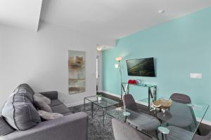 a living room with a couch and a glass table at Downtown Apartments 18 in Toronto