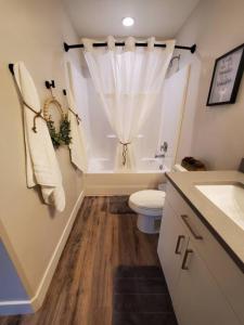 a bathroom with a toilet and a tub and a sink at Red Rock Suite - Castle Rock Condos in Richfield