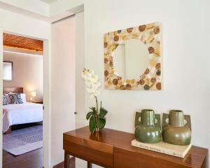 a room with a table with a mirror and a bed at AmazINN Places Penthouse en el corazon de La Condesa in Mexico City