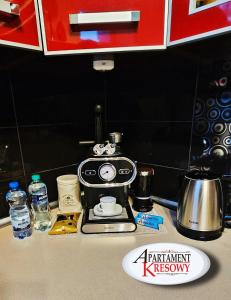 a coffee maker sitting on top of a counter at APARTAMENT KRESOWY parter 3 pokoje duża łazienka kabino-wanna SPA wi fi ekspres 2x smart tv antresola parking free plac zabaw bilet na aquapark 150m w cenie in Hrubieszów +18 photos