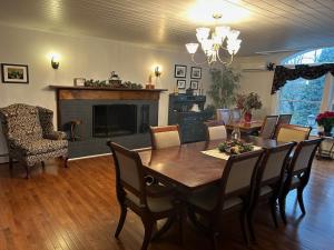 a dining room with a table and a fireplace at 37 Oak Ridge House in Wellsboro