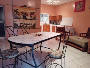 a kitchen with a table and chairs in a room at Chez Sandrine in Ouoran