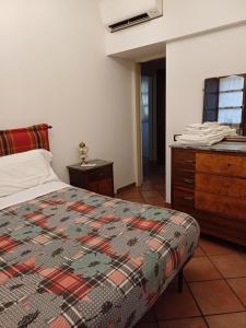 a bedroom with a bed and a dresser at Agriturismo San GIovanni Ad Insulam in Isola del Gran Sasso dʼItalia