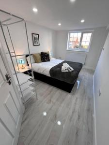 a bedroom with a bed and a ladder in it at Cathedral Walk 3 Bed Coachhouse in Lichfield
