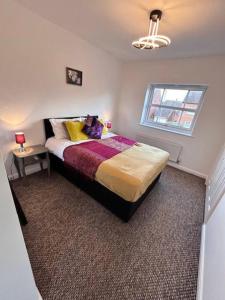 a bedroom with a bed with a teddy bear on it at Cathedral Walk 3 Bed Coachhouse in Lichfield