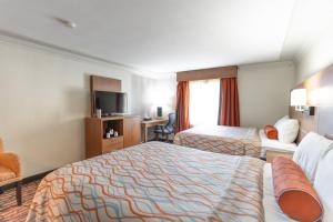 Ένα ή περισσότερα κρεβάτια σε δωμάτιο στο Kalika Hotel