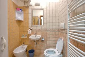 a bathroom with a toilet and a sink at Casa Athena - Goelba in Portoferraio +12 photos