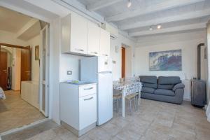 a kitchen with a refrigerator and a table in a room at Casa Athena - Goelba in Portoferraio