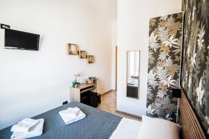 a hotel room with a bed and a mirror at Hotel Dell'Urbe in Rome