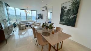 a dining room and living room with a table and chairs at 09I Jungle/Ocean View to thrill Nature Enthusiasts in Panama City