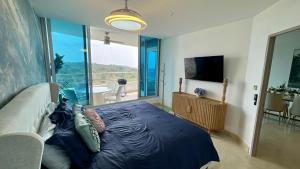 a bedroom with a bed and a large window with a view at 09I Jungle/Ocean View to thrill Nature Enthusiasts in Panama City