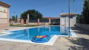 a swimming pool with a inflatable boat in it at Casa el Tempranal in Yuncler