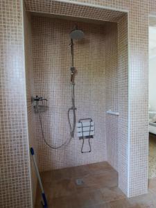 a shower in a tiled bathroom with a shower at Finca Caracol in Bolulla