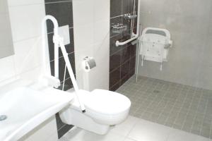 a bathroom with a white toilet and a sink at Appartement d'une chambre avec sauna et wifi a La Ferriere aux Etangs in La Ferrière-aux-Étangs