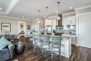 a kitchen and living room with a table and chairs at Smooth Sailing by Brightwild-Pool & Boat Dock in Key West