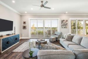 a living room with a couch and a tv at Coastal Bliss by Brightwild-Pool, Parking, Dock! in Key West