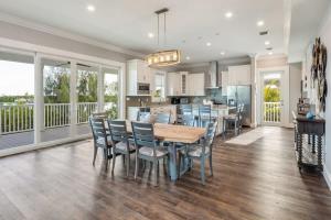 a kitchen and dining room with a table and chairs at Coastal Bliss by Brightwild-Pool, Parking, Dock! in Key West