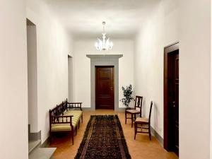 a hallway with a couch and chairs and a door at Borgia di Firenze in Florence