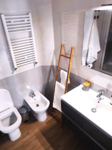 a bathroom with a toilet and a sink and a toilet istg at Michelangelo Airport Suite Room in Fiumicino