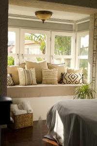 a window seat in a bedroom with pillows on it at Aleysim Alaçatı-Design Als in Alaçatı