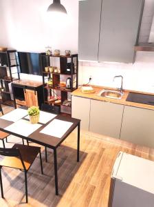 a kitchen with a table and chairs and a sink at Michelangelo Airport Suite Room in Fiumicino