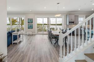 a dining room and living room with a table and a kitchen at Sophisticated Sunsets by Brightwild-Pool & Dock! in Key West