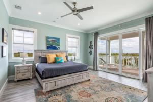a bedroom with a bed with a ceiling fan at Sophisticated Sunsets by Brightwild-Pool & Dock! in Key West