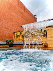 a water fountain in front of a brick building at Hotel St-Thomas in Montréal