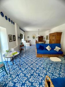 un soggiorno con divano blu e tavolo di La Cuchina a Capri