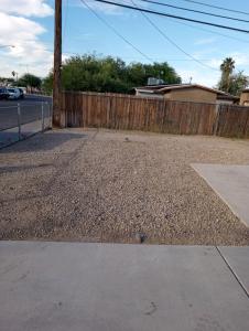 an empty driveway next to a wooden fence at Birdys Nest in Las Vegas