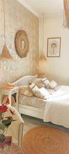 a bedroom with a white bed and a mirror at La Lucques Masabelle in Mirepeisset +45 photos