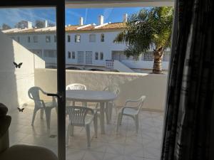 a patio with a table and chairs on a balcony at Spacious, calm and bright Duplex Apartment in Private Residence ideal for families, beach and golf in Sitio de Calahonda +16 photos