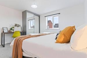 a bedroom with a white bed with yellow pillows at Anglian Retreat - Close to City Centre - Free Parking, Fast Wifi and Smart TV by Yoko Property in Coventry