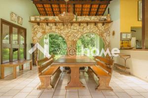 a dining room with a table and a stone fireplace at Sítio com piscina e churrasqueira em Indaiatuba in Campinas